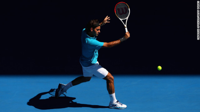 Roger Federer of Switzerland plays a backhand in his first-round match against Benoit Paire of France during day two of the 2013 Australian Open in Melbourne on Tuesday, January 15. Federer defeated Paire 6-2, 6-4, 6-1. The two-week tennis tournament continues through January 27.