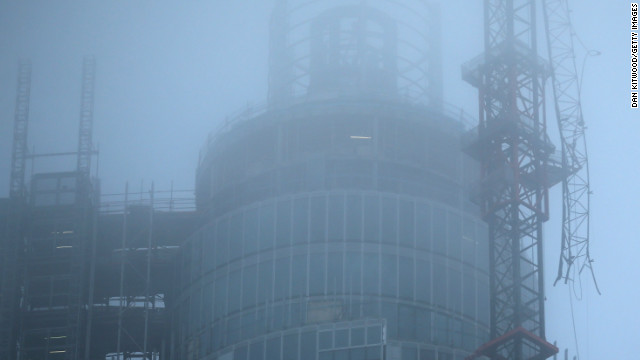 Fog surrounds a damaged crane attached to St Georges Wharf Tower after a helicopter reportedly collided with it.