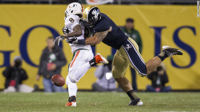 Te'o tackles Miami running back Duke Johnson during the Fighting Irish game against the Miami Hurricanes in Chicago on October 6. Notre Dame defeated Miami 41-3. 