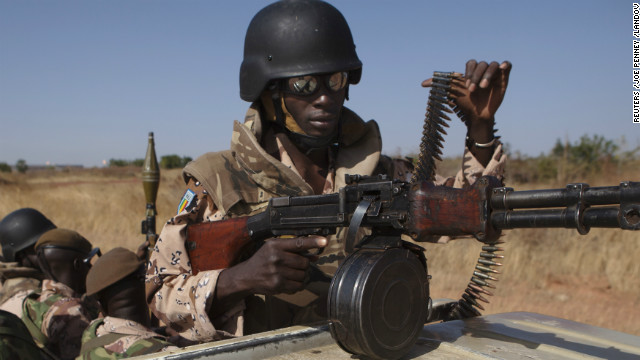 A Malian soldier adjusts his weapon as President Traore speaks to French troops at an air base in Bamako on January 16.