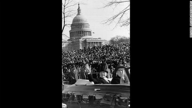 President Harry S. Truman waves to the crowd from a car during a parade after his inauguration speech on January 20, 1949.