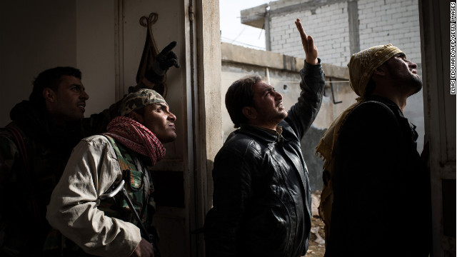 Rebel fighters try to locate a government fighter jet in the sky above Aleppo during fighting on January 18.