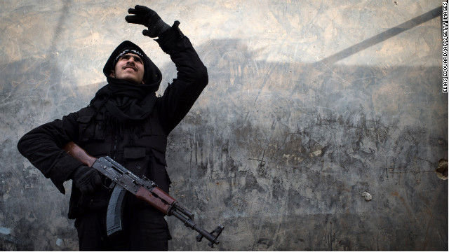 A Syrian rebel fighter tries to locate a government jet fighter in Aleppo on January 18. 