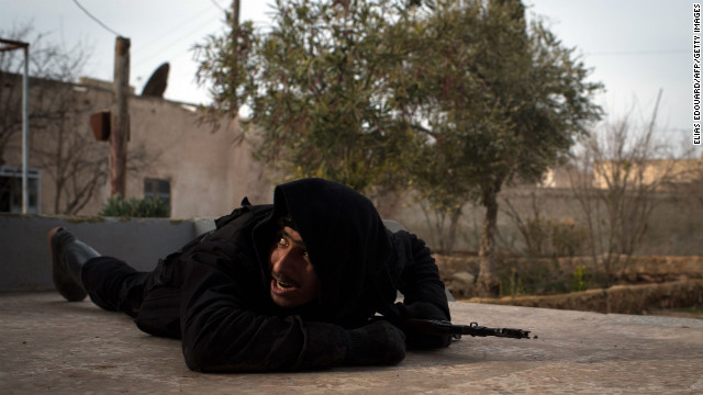 A rebel fighter ducks for cover from government jet fighters in Aleppo on January 18.