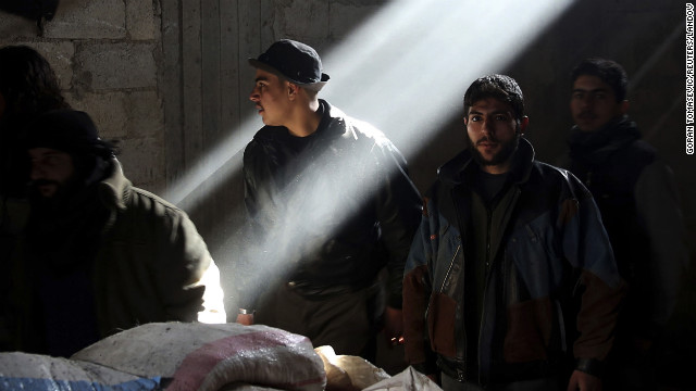 Rebel fighters stand in a house at a frontline in the Arabeen neighborhood of Damascus on January 19.