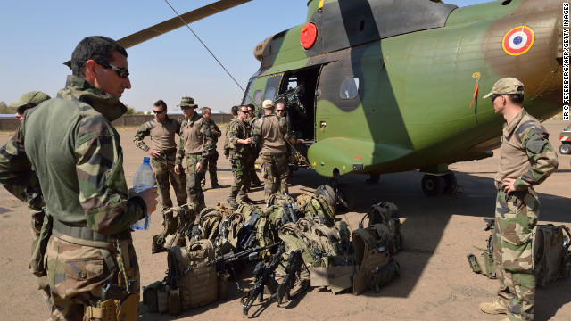 French soldiers of the 5th Combat Helicopter Regiment stand with their equipment in front of a helicopter on January 19 at an airbase near Bamako, Mali. French Defense Minister Jean-Yves Le Drian said on January 19 that France now had 2,000 troops on the ground in Mali as part of a drive against Islamist militants holding the north of the country.