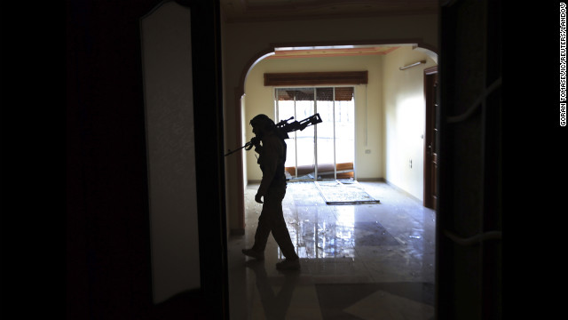 A fighter walks inside a house during heavy fighting in Mieha suburb of Damascus on January 22.