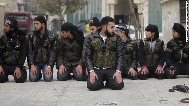 Members of the Free Syrian Army pray on one of the streets of Aleppo on January 21.
