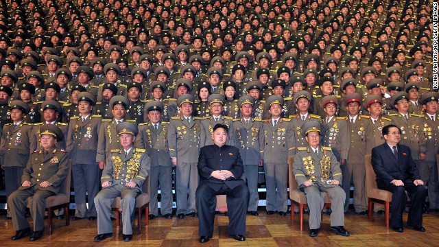 North Korean leader Kim Jong Un, center, poses with chiefs of branch social security stations in this undated picture released by North Korea's official news agency on November 27, 2012. 