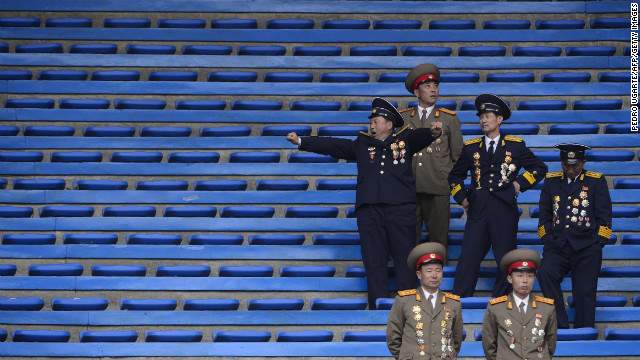 North Korean soldiers relax at the end of an official ceremony attended by leader Kim Jong Un at a stadium in Pyongyang in April 2012.