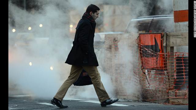 A man walks past a steam vent on Madison Avenue in Manhattan in the early morning of January 24.