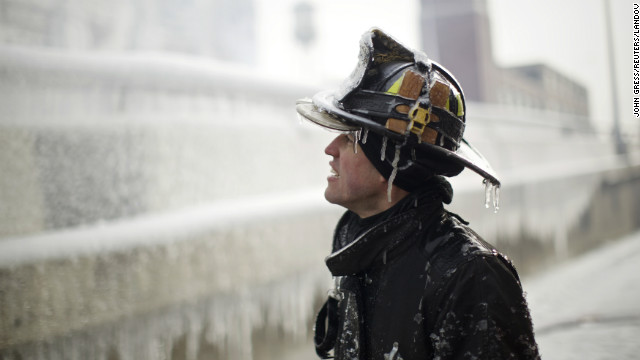 Ice covers firefighter Michael De Jesus while he mans a water cannon at the scene of a warehouse fire in Chicago on January 24.