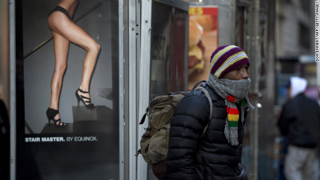 A man keeps bundled up as he waits to cross the street in New York on January 23.