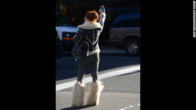 A woman hails a taxi on Lexington Avenue on Manhattan's Upper East Side on January 24.