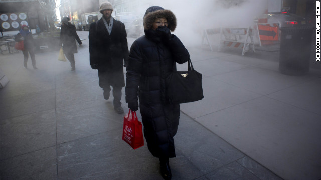 A woman keeps covered up as steam rises from the street on January 23 in New York.