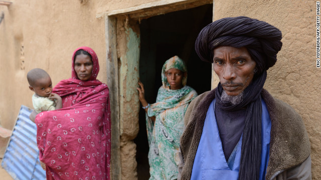 Ali Ag Noh, right, stands with his family in front of his house on Friday, Janurary 25, in the village of Seribala, Mali, after his cousin and brother-in-law, Aboubakrim Ag Mohamed, and a cattle rancher, Samba Dicko, were shot dead on January 24, allegedly by the Malian Army. According to Noh, Mohamed, a Tuareg, and Dicko were shot in the head in Seribala after being accused by two Malian soldiers of being Islamists or aiding Islamists.