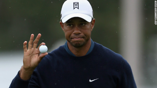 Tiger Woods signals to the gallery after making an eagle putt on the 18th hole at Torrey Pines.