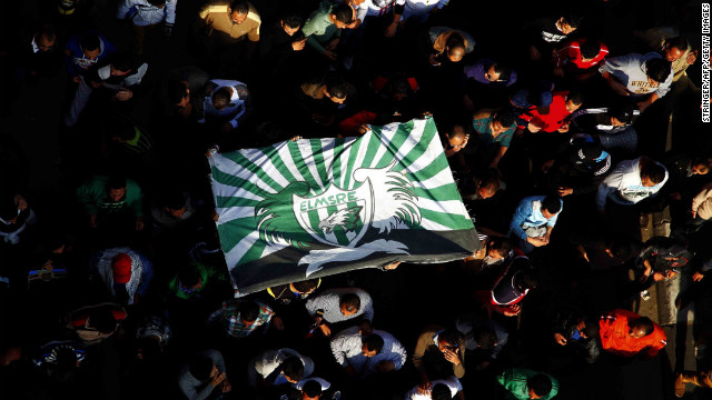 Egyptian protesters and fans of Al-Masry football club wave their club colors as they take part in a demonstration in front of the prison in the Egyptian Suez Canal city of Port Said on Friday, January 25, calling for the prisoners who are suspected of killing 74 fans of Al-Ahly club during a football match in February 2012 not to be transferred to Cairo to attend their trial. A judge sentenced 21 people to death for their roles in the riot last year.