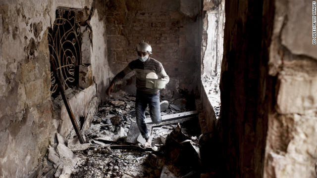 A protester walks through a damaged school building.