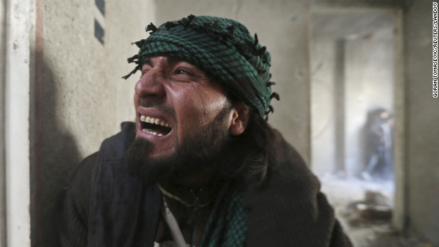 A rebel fighter screams in pain after being wounded by shrapnel from a hand grenade during heavy fighting in Damascus on January 26.
