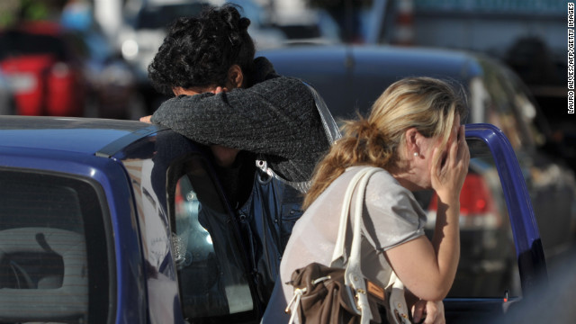 People cry after a getting news about the deadly fire.