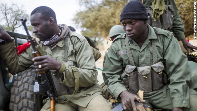 Malian soldiers wait at a checkpoint near Sevare on January 27.