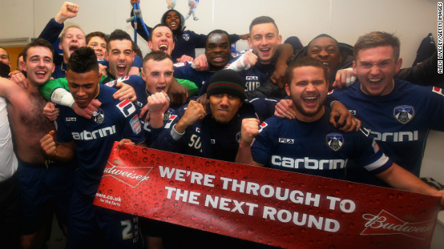 The players of third-tier side Oldham Athletic celebrate a shock FA Cup victory over Premier League Liverpool.