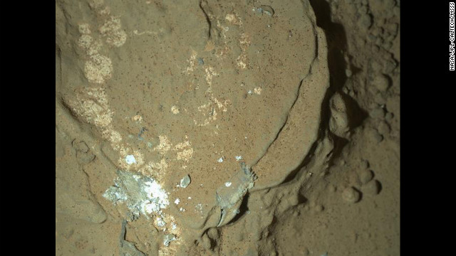 Another nighttime image includes this rock called Sayunei in the Yellowknife Bay area of Mars' Gale Crater. Curiosity's front-left wheel had scraped the rock to inspect for fresh, dust-free materials in an area where drilling for rock soon will begin.