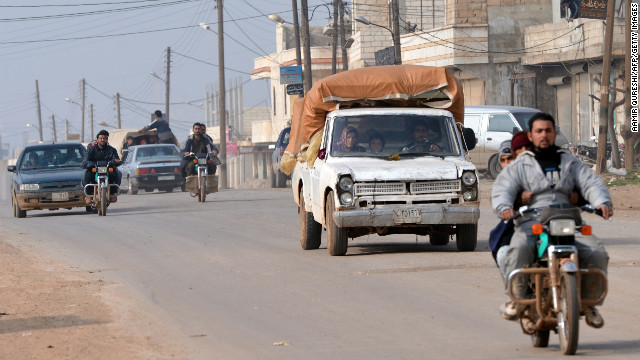 Syrian residents flee the village of Kurnaz due to fighting between rebels and regime forces on Sunday, January 27. 