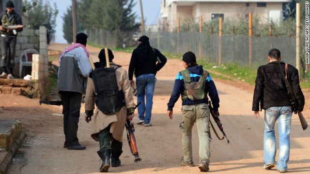 Rebel fighters take up positions in the village of Kurnaz on January 27.