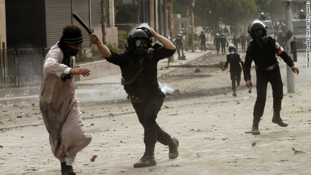 A riot police officer clashes with a protester near Cairo's Tahrir Square on January 28.