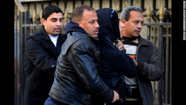 Police in plainclothes detain a youth suspected of being a member of the Black Bloc opposition group during a demonstration on January 30 in Cairo.