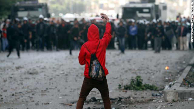 A protester faces off against riot police during clashes near Cairo's Tahrir Square on Wednesday, January 30.