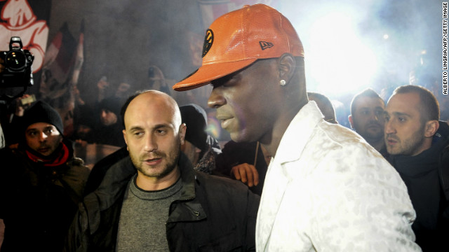 Mario Balotelli was mobbed by fans outside a restaurant as he returned home to Italy ahead of completing his reported $30 million move tom AC Milan from Manchester City.