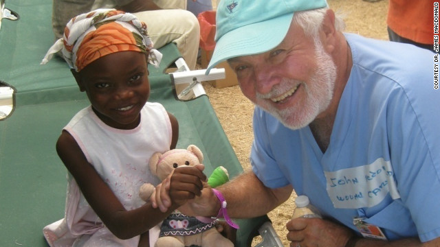 Dr. James Macdonald, here with a young patient in Haiti, runs a health clinic in Port-au-Prince that focuses on wound care.