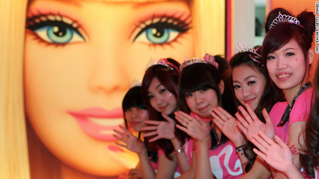 Tiaras and smiles at the opening of Taipei's Barbie Café on Wednesday. This welcome by staff a subtle hint at what lies further ahead.