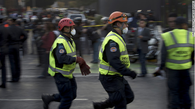 Black smoke billows from the 54-story skyscraper as rescue workers rush to free people trapped in the rubble.