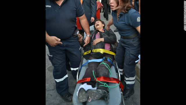 A woman receives medical attention on a stretcher after the explosion.