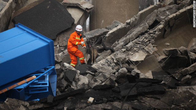 A rescuer looks for survivors at the scene near the city of Sanmenxia, Henan province, on February 1, 2013.