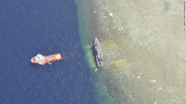 The U.S. Navy-contracted Malaysian tug Vos Apollo removes petroleum-based products and human wastewater on January 28 from the mine countermeasure ship USS Guardian, a U.S. Navy minesweeper trapped on a reef off the western Philippine island of Palawan since January 17.