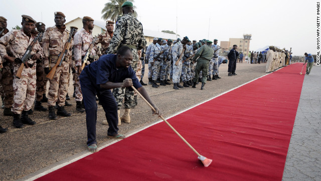 A man sweeps the red carpet at Mali's Mopti airport on January 2 before the arrival of Hollande and Mali's interim President Dioncounda Traore.