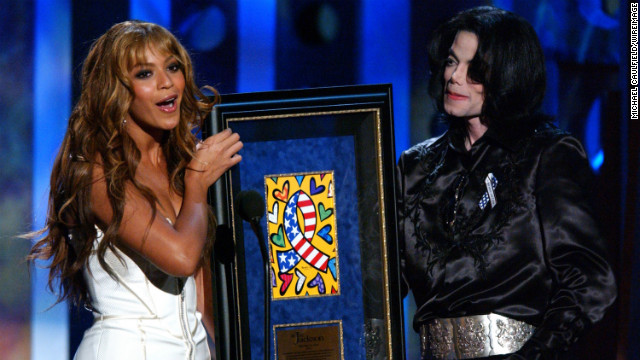 Having stepped out on her own, Beyoncé presents the humanitarian award to Michael Jackson at the 2003 Radio Music Awards in Las Vegas on October 27, 2003.