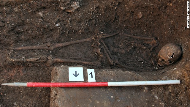 The skeleton being excavated, shows the curve in the spine and the way the head had been squashed into the grave. The hands may also have been tied.