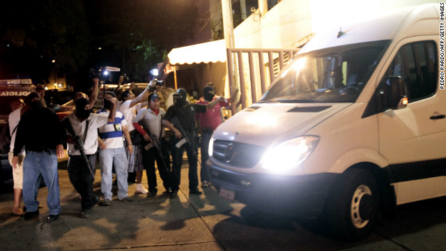 Police escort a van with twelve Spanish citizens and a Mexican woman in Acapulco on February 4, 2013.