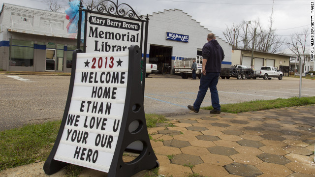 A sign celebrating Ethan's rescue stands in front of the Mary Berry Brown Memorial Library in Midland City on February 5.