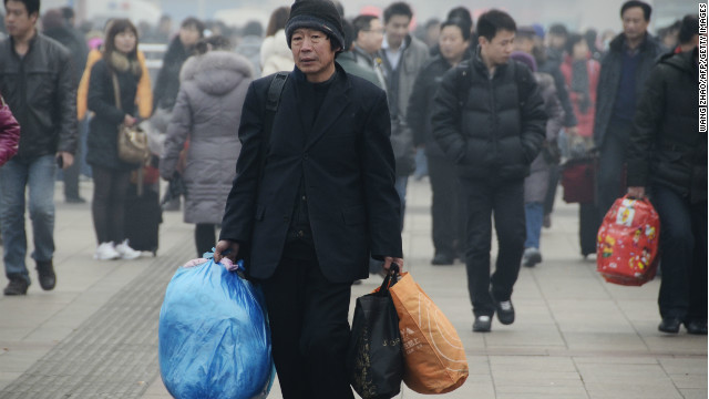 A man prepares to take the train at the entrance of Beijing Railway Station on January 28. 