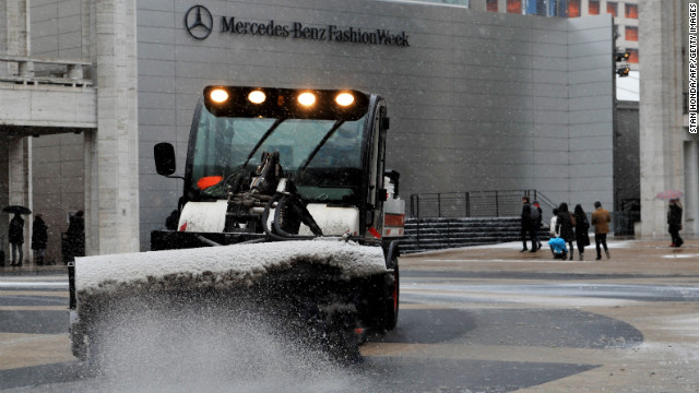 A sweeper clears snow in front of the Mercedes-Benz Fashion Week tents on February 8 at Lincoln Center in New York.