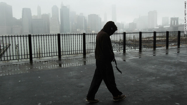 A man walks along the promenade in Brooklyn Heights as Lower Manhattan stands in a cloud of snow and sleet in the early hours of a major winter storm on February 8.