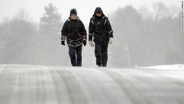 Ines Cuadrado, left, and Anne Levine trek along a snow-covered road in Middlefield, Connecticut, on February 8. The heaviest snowfall will extend into Connecticut, Rhode Island and eastern Massachusetts, forecasts say, and governors in all three states have declared states of emergency.<!-- -->
</br>