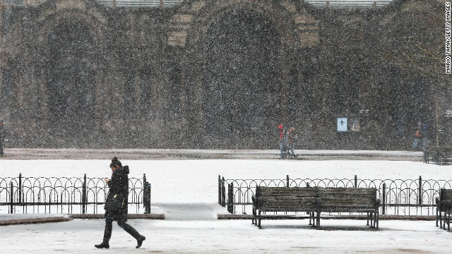 A woman walks through the snow past Copley Square on Friday in Boston. Massachusetts and other states from New York to Maine are preparing for a major blizzard with possible record amounts of snowfall in some areas.